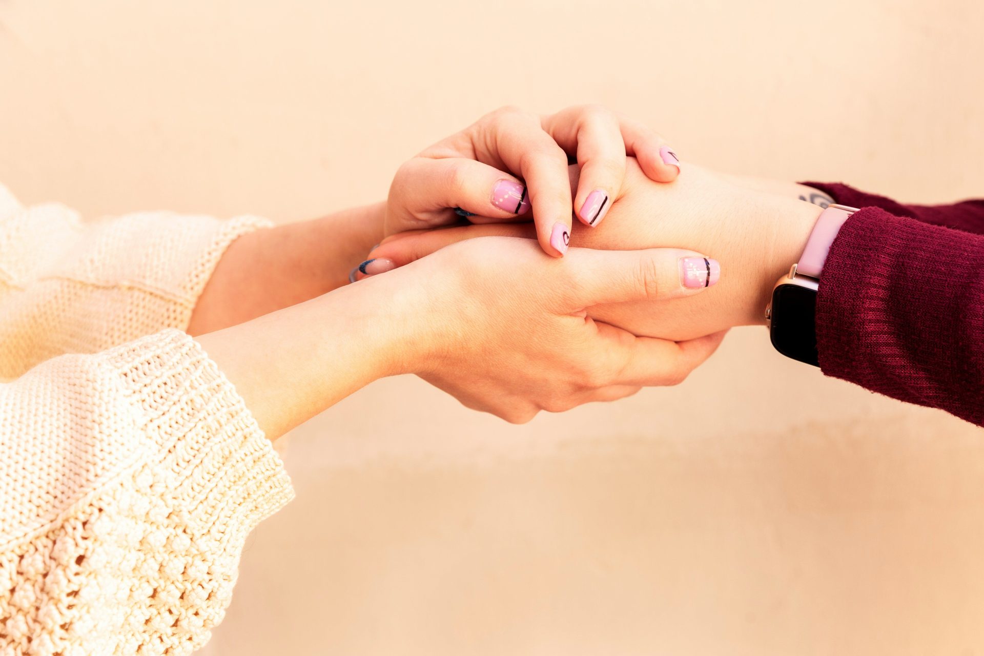 a close-up of hands holding each other